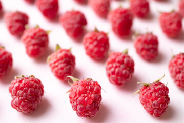 Fresh ripe raspberry with leaf on pink background, Summer fruit
