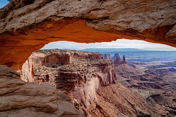 Mesa Arch frames the breathtaking view of Canyonlands National Park, USA, showcasing dramatic red...
