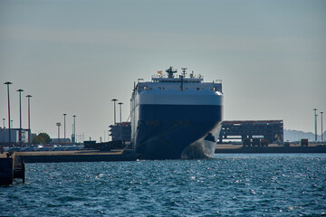 Huge car carrier ship moored in the Galician port of Vigo, with details of port facilities in the background