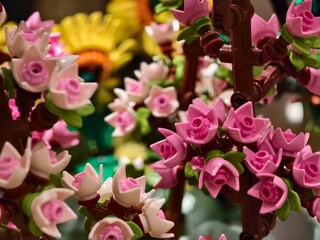 A colorful bunches of flowers constructed entirely out of bricks 