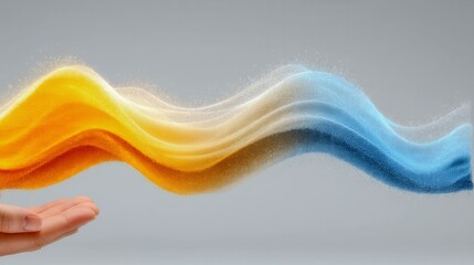 A hand is holding a wave of light that is yellow and blue. The colors are swirling together, creating a sense of movement and energy. The image conveys a feeling of excitement and wonder