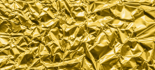 Luxury shiny metallic golden foil crumpled texture background