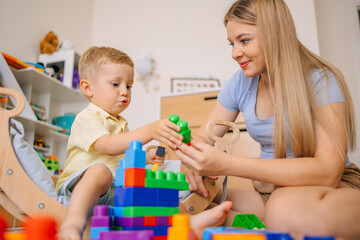 Mother and Child Playing with Colorful Building Blocks in a Bright Living Room