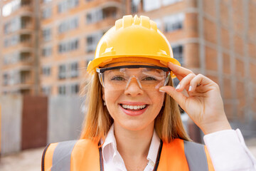 Smiling Female Construction Worker Wearing Safety Gear at the Construction Site