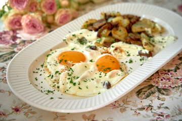 A Delicious Breakfast Plate Featuring Softly Cooked Eggs Served with Seasoned Potatoes on a Floral Table Setting for a Cozy Meal Experience