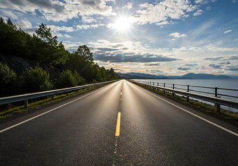 Fototapeta premium Scenic road trip: a straight highway running parallel to a vast, sun-drenched body of water.