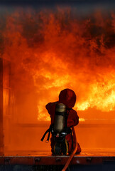 Vertical Horizon Firefighter Rescue training in fire fighting extinguisher. Firefighter fighting...