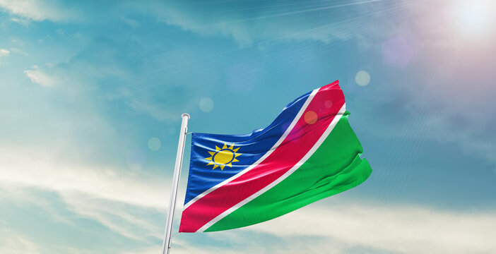 Namibia national flag waving with beautiful sky.