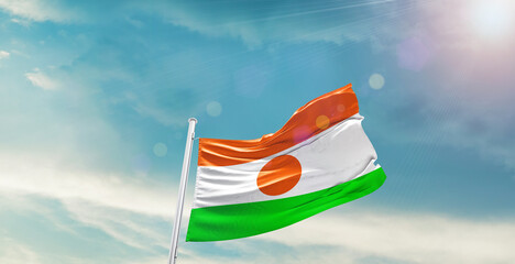 Niger national flag waving with beautiful sky.