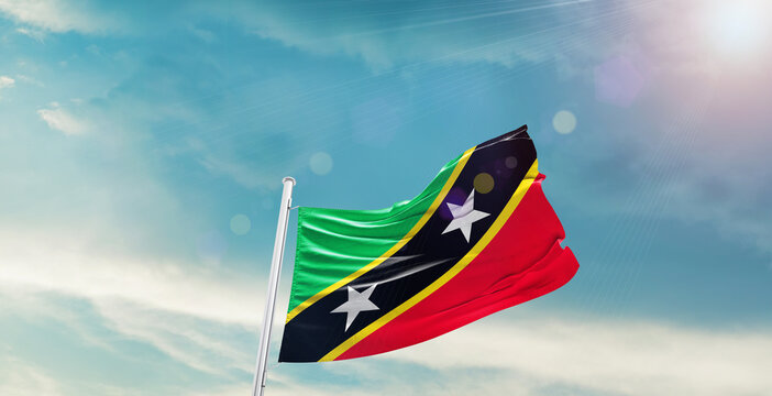 Saint Kitts and Nevis national flag waving with beautiful sky.