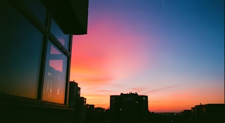 Vibrant Sky Over City Skyline at Dusk A Beautiful Sunset with Colorful Hues Reflected in Windows
