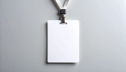 Blank white identity card with a lanyard hanging on a gray background. A clean template for a name tag or access pass mockup.