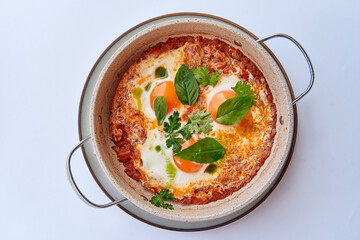 A Deliciously Garnished Dish Featuring Eggs Poached in a Savory Tomato Sauce with Fresh Herbs, Perfect for Breakfast or Brunch