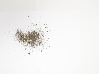 Pile of dried tea leaves isolated on white background. top view.
