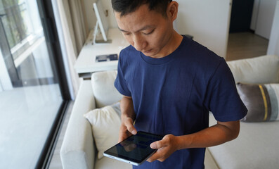 Worker with tablet computer checking alarm system