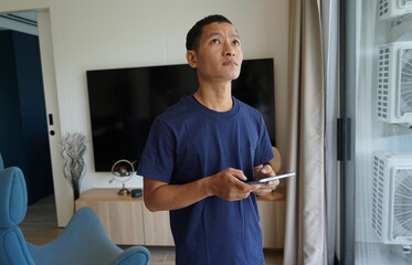 Worker with tablet computer checking alarm system