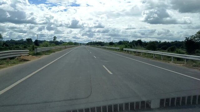 Straight road with beautiful clouds in rural Tripura.