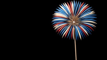 A festive burst of red white and blue radiates from a paper decoration against a stark black backdrop symbolizing celebration and national pride beautifully.