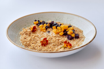A Delicious Bowl of Oatmeal Garnished with Dried Fruits and Edible Flowers, Perfect for a Healthy Breakfast to Start Your Day Right