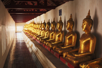 Phitsanulok, Thailand- 26 October 2013: Golden Buddha statues lined up. Phra Rabiang is one of the elements built around the Wat Phra Si Rattana Mahathat Woramahawihan Temple