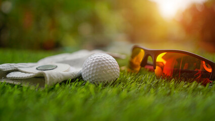 Close up of golf equipment on green grass.