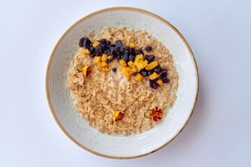 A Delicious Bowl of Oatmeal Topped with Fresh Fruits and Nuts, Perfect for a Nutritious Breakfast Filled with Flavor and Texture Enhancements
