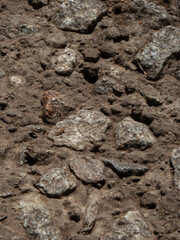 Close-Up View of Rough, Textured Ground with Embedded Rocks