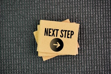 Paper with the words next step. the immediate or subsequent action, move, or phase in a sequence or...