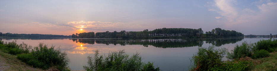 Panoramic view of the Po River at sunset with reflections in San Nazzaro Italy