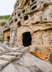 Fototapeta premium View of the stone carving at historic Longmen Grottoes in Luoyang, China.