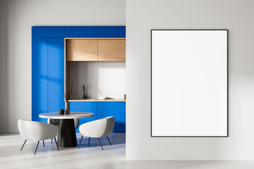 Modern interior with blue kitchen cabinets, minimalist dining area, and large empty framed poster on clean white wall for design presentation mockup. 3D Rendering