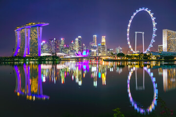 View of the skyline at the Downtown Core along Marina Bay at night in Singapore.