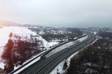 Highway cutting through winter countryside scenery