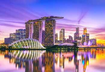 View of the skyline at the Downtown Core along Marina Bay at dusk in Singapore.