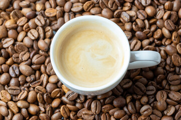 Cup of coffee with roasted coffee beans