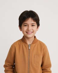 East Asian child boy wearing plain amber jacket smiling happy portrait on plain white background