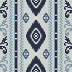Seamless indigo ikat patterns in ethnic tribal style, featuring geometric diamond shapes and woven texture in blue tones.