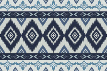 Seamless indigo ikat patterns in ethnic tribal style, featuring geometric diamond shapes and woven texture in blue tones.