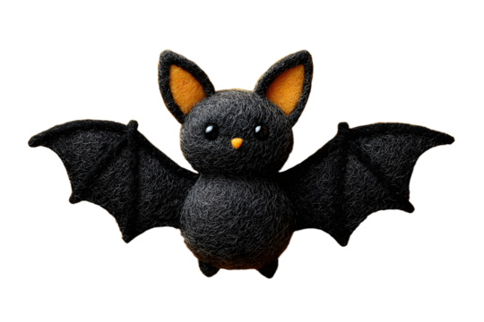 A black bat sewn from felt on a yellow background. A toy for Halloween.