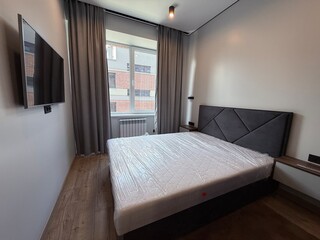 Modern Minimalist Bedroom Interior with Large Window and TV