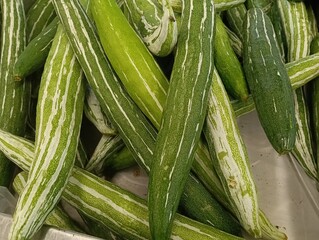Snake gourd vegetables on display in a market in malaysia
