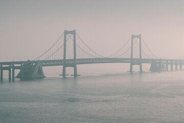 bridge in the fog over the sea