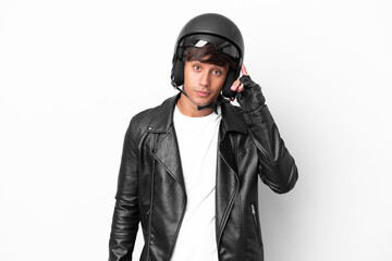 Young man with a motorcycle helmet isolated on white background thinking an idea