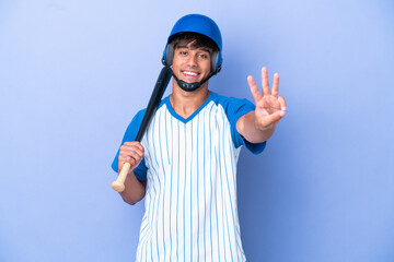 Baseball caucasian man player with helmet and bat isolated on blue background happy and counting three with fingers