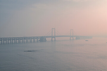 bridge in the fog over the sea