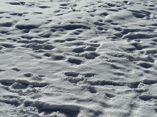 Footprints in deep snow in winter.