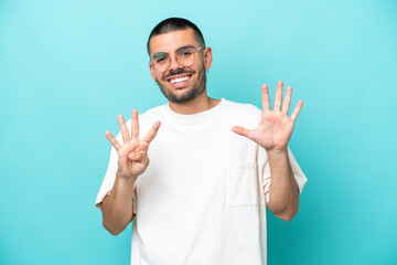 Young caucasian man isolated on blue background counting nine with fingers
