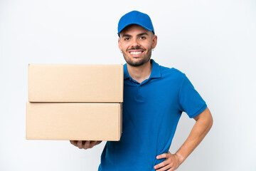 Delivery caucasian man isolated on white background posing with arms at hip and smiling
