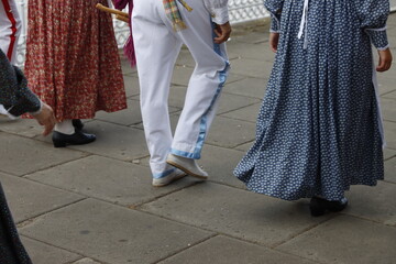 People marching in traditional Basque folk costume