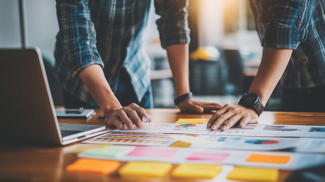 Team analyzes data on table. Business partners collaborate, plan strategy. Workplace. Marketing, web, design, editorial use.